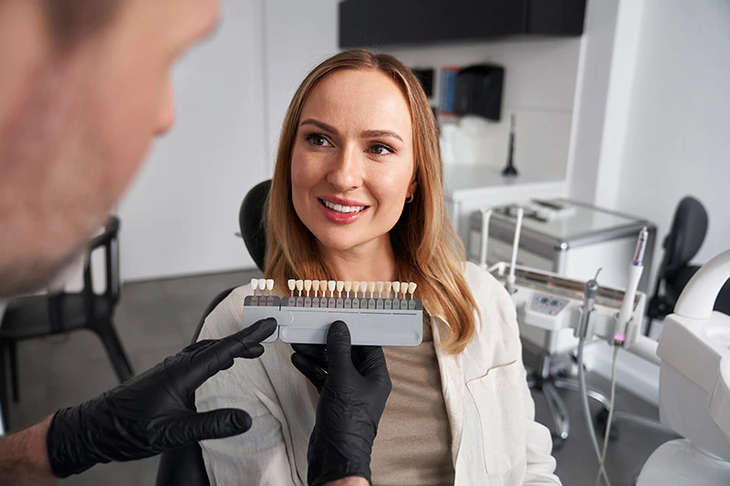 patient choosing a shade of dental veneers at Lee Dentistry