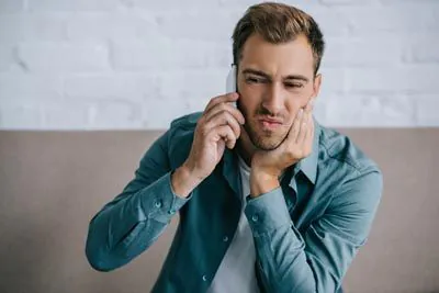 man calling Lee Dentistry for emergency dental help
